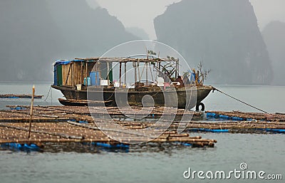 Fishing boat at fish farm in Halong bay, Vietnam