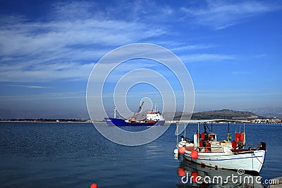 Fishing boat and old cargo ship - Greece