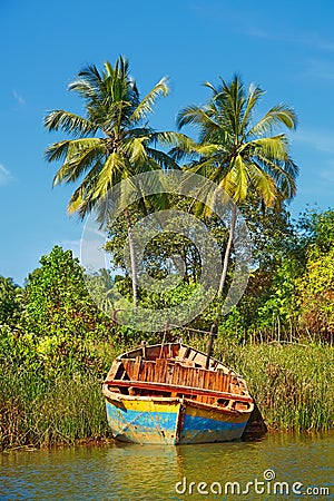 Fishing boat on the shore of a tropical river.