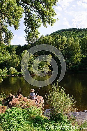 Boy fishing by river