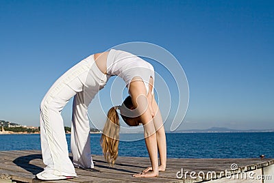 Fit healthy woman doing back bend