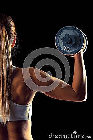 Fitness girl - attractive young woman working out with dumbbells