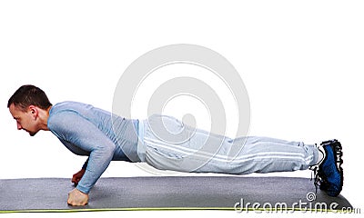Fitness man doing push ups on mat