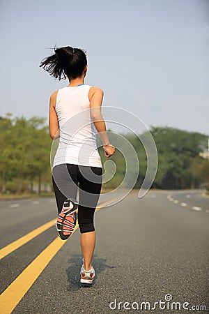 Fitness oman running at city street