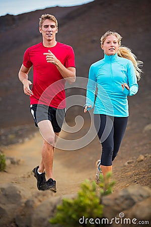 Fitness sport couple running jogging outside on trail