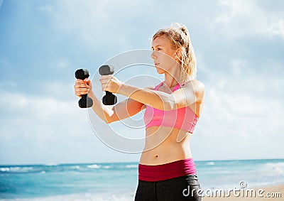 Fitness woman with barbells working out