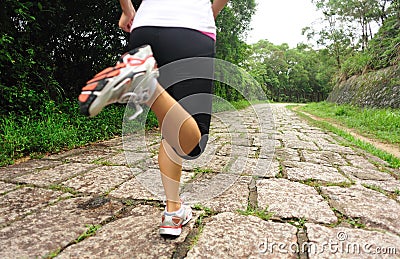 Fitness woman runner running on trail