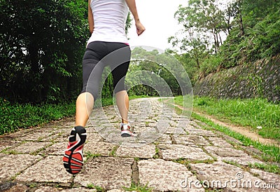 Fitness woman runner running on trail