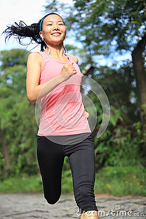 Fitness woman runner running on trail