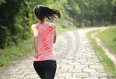 Fitness woman runner running on trail
