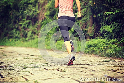 Fitness woman runner running on trail