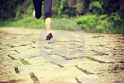 Fitness woman runner running on trail