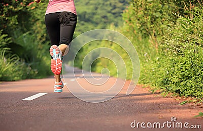 Fitness woman runner running on trail