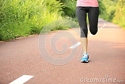 Fitness woman runner running on trail