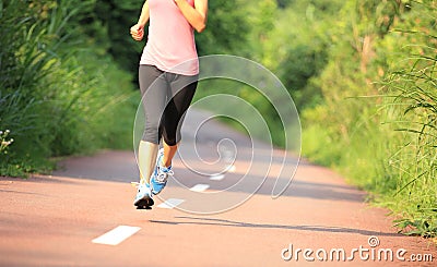 Fitness woman runner running on trail