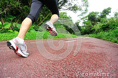 Fitness woman runner running on trail