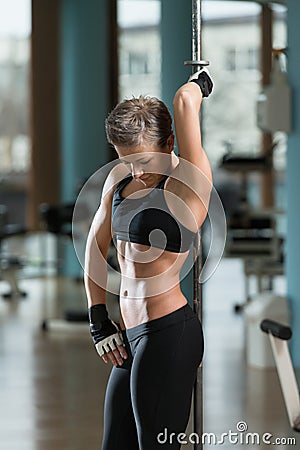 Fitness Women Flexing Muscles In A Healthy Club