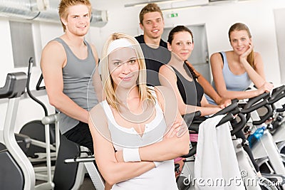 Fitness young group people at gym bicycle