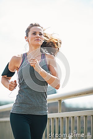 Fitness young woman jogging in the city