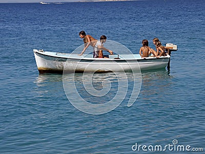 Five children in fun on boat at sea