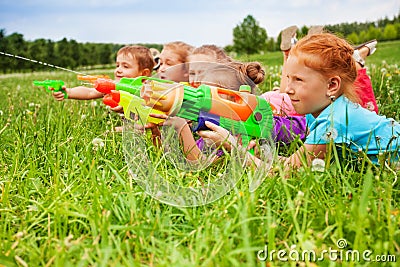 Five kids play with water guns