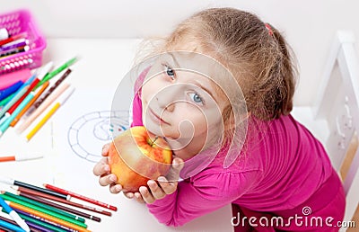 Five years old caucasian blond child girl with apple