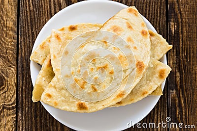 Flat bread on a white plate viewed from above