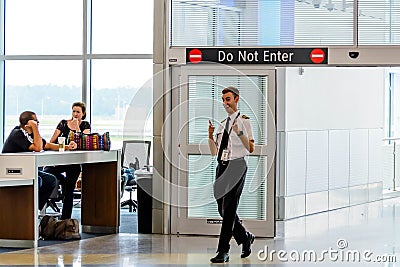 Flight personnel giving the thumbs up entering the boarding gate