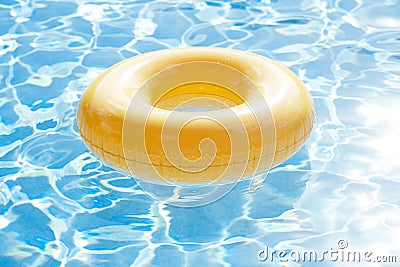 Floating ring on blue water swimpool with waves reflecting