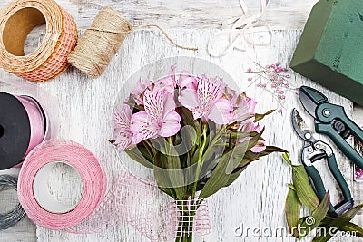 Florist at work: woman arranging bouquet of alstroemeria flowers