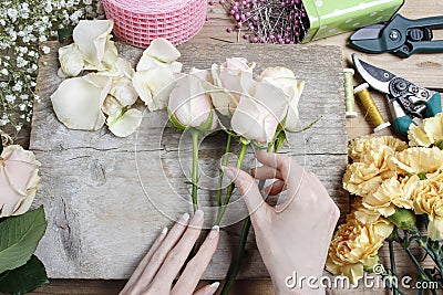 Florist at work. Woman making wedding bouquet