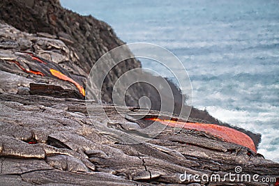 Flow of red hot lava into Pacific Ocean