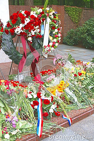 Memorial monument with flowers and Dutch flags