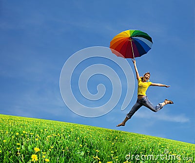 Flying girl with colorful umbrella on the blue bl