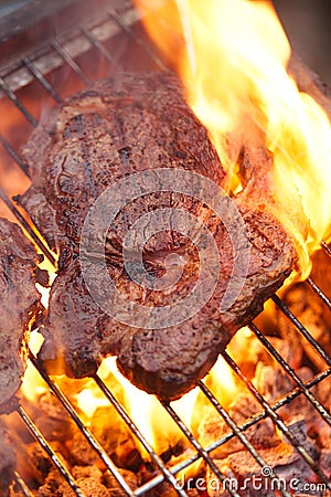 Food meat - rib eye beef steak on party summer barbecue grill wi