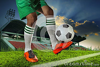 Foot ball player holding foot ball on leg ankle on soccer sport