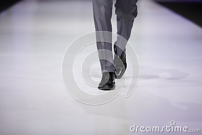 Foot of male model on catwalk