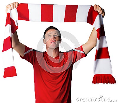 Football fan in red holding scarf