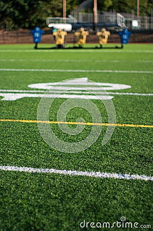 Football field with practice dummy sled in background