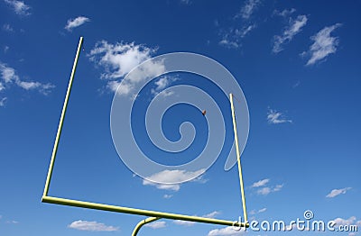 Football kicked through the Goal Posts