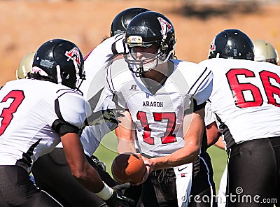 Football Player Quarterback Handing The Ball During A Game