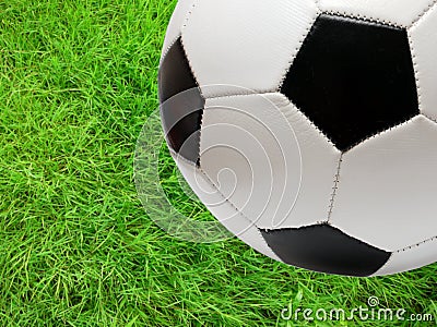 Football soccer ball over green grass