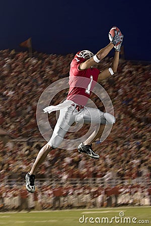 Football Wide Receiver Making a Leaping Catch