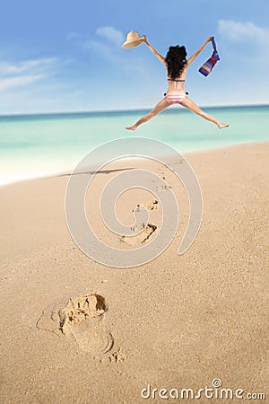 Footprints and excited woman jumping