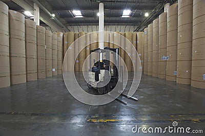 Forklift Truck And Huge Rolls Of Paper In Factory