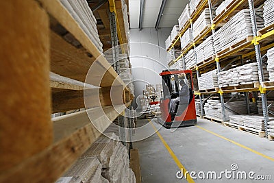 Forklift working in a wood warehouse