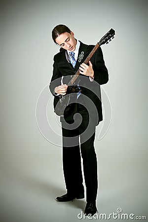 Formal man playing on guitar