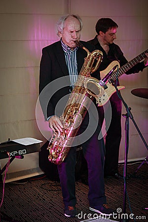 Founder of IDS Scheer software company professor Scheer playing saxophone