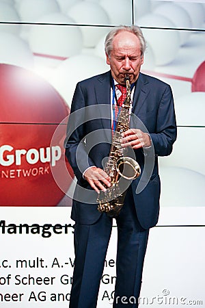 Founder of IDS Scheer software company professor Scheer playing saxophone