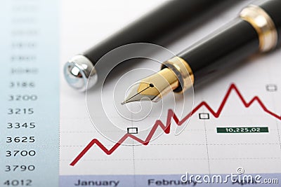 Fountain pen on business charts and graph